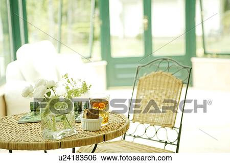 Stock Photograph - Table and chair in conservatory. Fotosearch