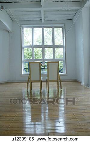 Two chairs in an empty room View Large Photo Image Stock Photography - Two chairs in an empty room. Fotosearch