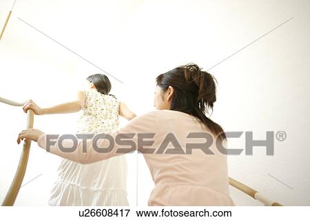 Stock Photo - Two young women going up stairs. Fotosearch
