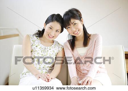Two young women looking at camera View Large Photo Image Picture - Two young women looking at camera. Fotosearch
