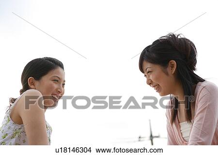 Two young women smiling View Large Photo Image Picture - Two young women smiling. Fotosearch