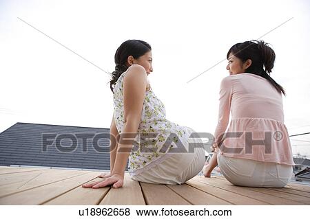 Stock Photo - Two young women talking. Fotosearch