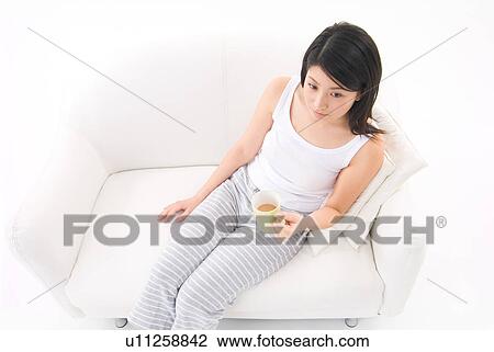 Young woman drinking coffee View Large Photo Image Stock Image - Young woman drinking coffee. Fotosearch
