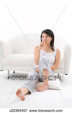 Young woman eating cookie View Large Photo Image Stock Photo - Young woman eating cookie. Fotosearch