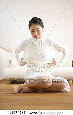 Young woman getting dressed View Large Photo Image Picture - Young woman getting dressed. Fotosearch