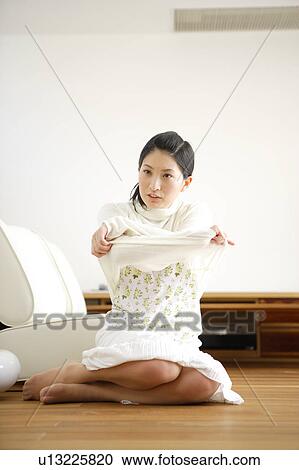 Young woman getting dressed View Large Photo Image Stock Image - Young woman getting dressed. Fotosearch
