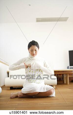 Young woman getting dressed View Large Photo Image Stock Image - Young woman getting dressed. Fotosearch