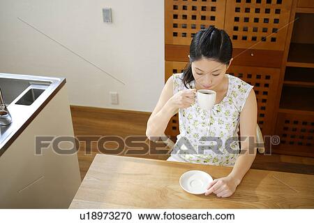 Young woman having coffee View Large Photo Image Stock Image - Young woman having coffee. Fotosearch