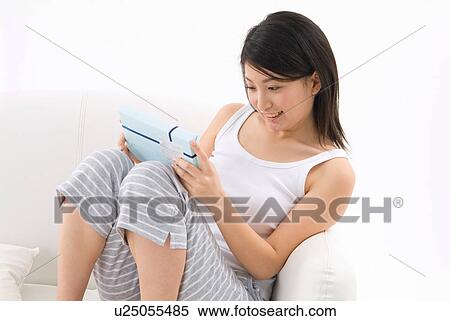 Stock Photography - Young woman holding gift. Fotosearch
