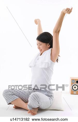 Young woman sitting with arms outstretched View Large Photo Image Stock Image - Young woman sitting with arms outstretched. Fotosearch