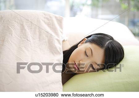 Young woman sleeping in bed View Large Photo Image Stock Image - Young woman sleeping in bed. Fotosearch