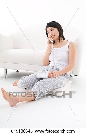 Young woman talking on phone View Large Photo Image Stock Photography - Young woman talking on phone. Fotosearch
