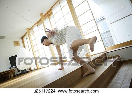 Picture - Young woman tripping over step. Fotosearch