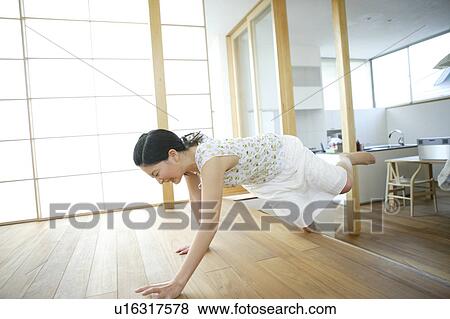 Stock Photo - Young woman tripping over step. Fotosearch