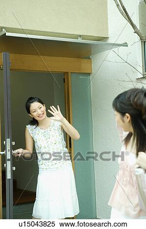 Young woman waving goodbye to friend View Large Photo Image Stock Photography - Young woman waving goodbye to friend. Fotosearch