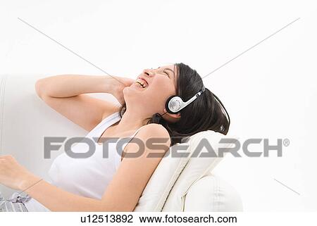 Young woman wearing headphones View Large Photo Image Stock Image - Young woman wearing headphones. Fotosearch
