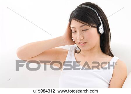 Young woman wearing headphones View Large Photo Image Stock Image - Young woman wearing headphones. Fotosearch