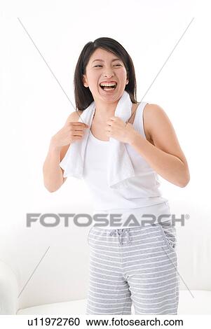 Young woman with towel around neck View Large Photo Image Stock Image - Young woman with towel around neck. Fotosearch