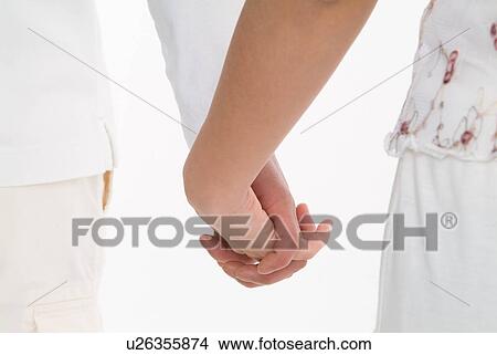 Close-up of couple holding hands View Large Photo Image Picture - Close-up of couple holding hands. Fotosearch