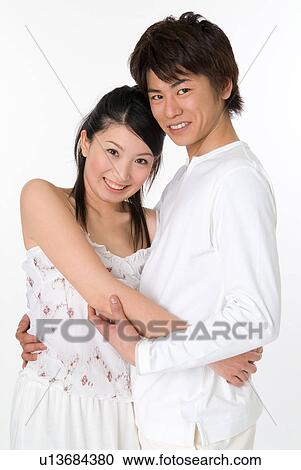 Stock Image - Young couple embracing. Fotosearch