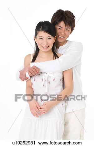 Stock Image - Young couple embracing. Fotosearch