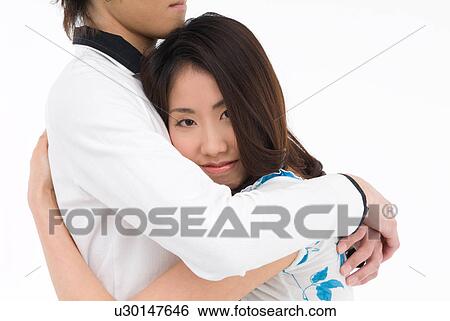 Stock Photograph - Young couple embracing. Fotosearch
