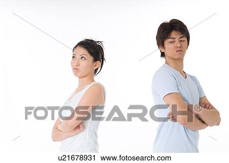 Stock Image - Young couple facing to relationship difficulties. Fotosearch