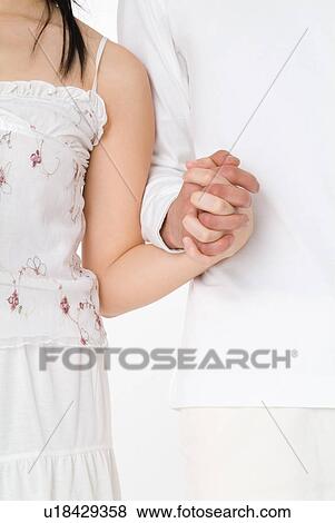 Young couple holding hands View Large Photo Image Stock Photo - Young couple holding hands. Fotosearch
