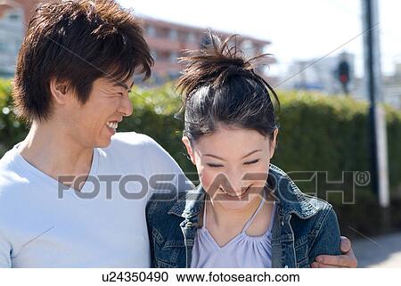 Stock Image - Young couple laughing. Fotosearch