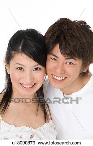 Stock Photo - Young couple looking at camera. Fotosearch