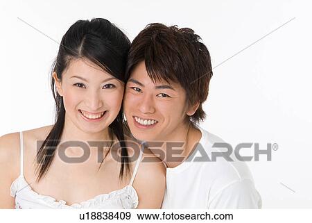 Young couple looking at camera View Large Photo Image Stock Photo - Young couple looking at camera. Fotosearch