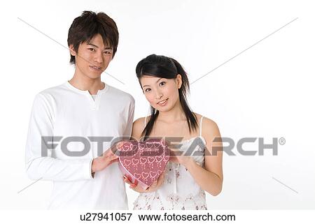 Stock Photo - Young couple looking at camera. Fotosearch