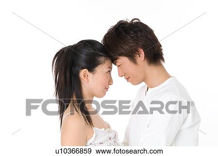Young couple looking at each other View Large Photo Image Stock Photo - Young couple looking at each other. Fotosearch
