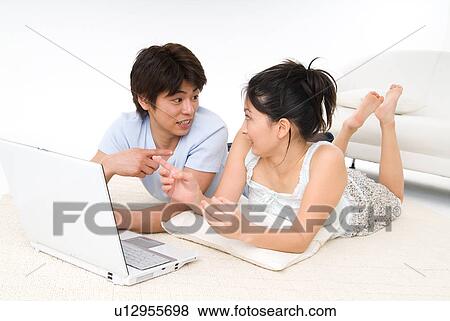Young couple looking at each other View Large Photo Image Stock Photo - Young couple looking at each other. Fotosearch
