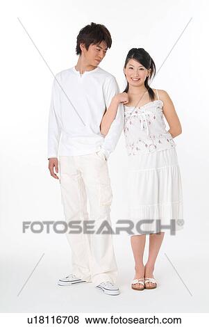 Young couple standing View Large Photo Image Stock Photo - Young couple standing. Fotosearch