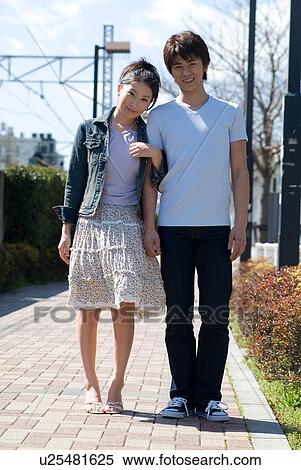 Stock Photography - Young couple standing. Fotosearch