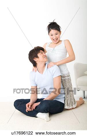 Young girl massaging her boyfriend's shoulder View Large Photo Image Stock Image - Young girl massaging her boyfriend's shoulder. Fotosearch