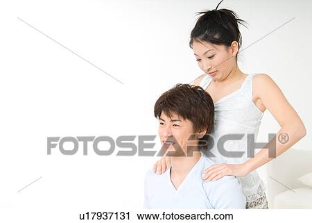 Young girl massaging her boyfriend's shoulder View Large Photo Image Stock Image - Young girl massaging her boyfriend's shoulder. Fotosearch