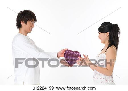 Stock Photograph Of Young Man Giving A Present To His Friend Stock Photograph Young Man Giving A Present To His Friend Fotosearch Search