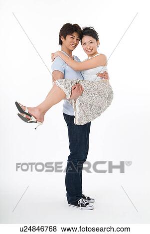 Young man lifting his girlfriend View Large Photo Image Stock Photo - Young man lifting his girlfriend. Fotosearch