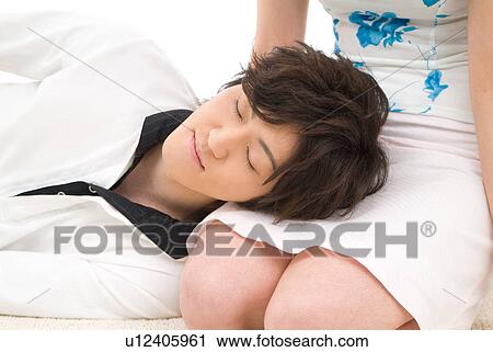 Young man sleeping with his head on woman's lap View Large Photo Image Stock Image - Young man sleeping with his head on woman's lap. Fotosearch