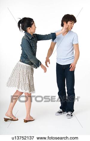 Young woman slapping her boyfriend View Large Photo Image Stock Photo - Young woman slapping her boyfriend. Fotosearch