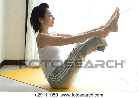 A mid adult woman doing yoga View Large Photo Image Stock Photo - A mid adult woman doing yoga. Fotosearch