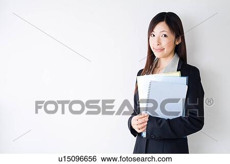 A mid adult woman holding documents View Large Photo Image Stock Photograph - A mid adult woman holding documents. Fotosearch