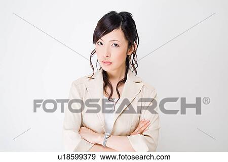 A mid adult woman looking at camera with her arms crossed View Large Photo Image Stock Photo - A mid adult woman looking at camera with her arms crossed. Fotosearch
