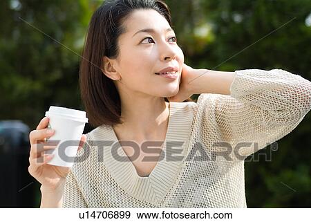 Stock Photo - A mid adult woman looking up. Fotosearch