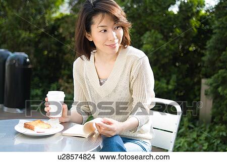 A mid adult woman reading a book View Large Photo Image Picture - A mid adult woman reading a book. Fotosearch