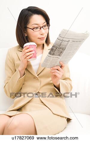 A mid adult woman reading newspaper View Large Photo Image Stock Photo - A mid adult woman reading newspaper. Fotosearch