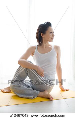 A mid adult woman stretching View Large Photo Image Stock Image - A mid adult woman stretching. Fotosearch