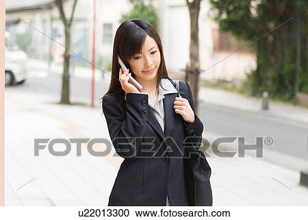 A mid adult woman using mobile phone View Large Photo Image Stock Image - A mid adult woman using mobile phone. Fotosearch